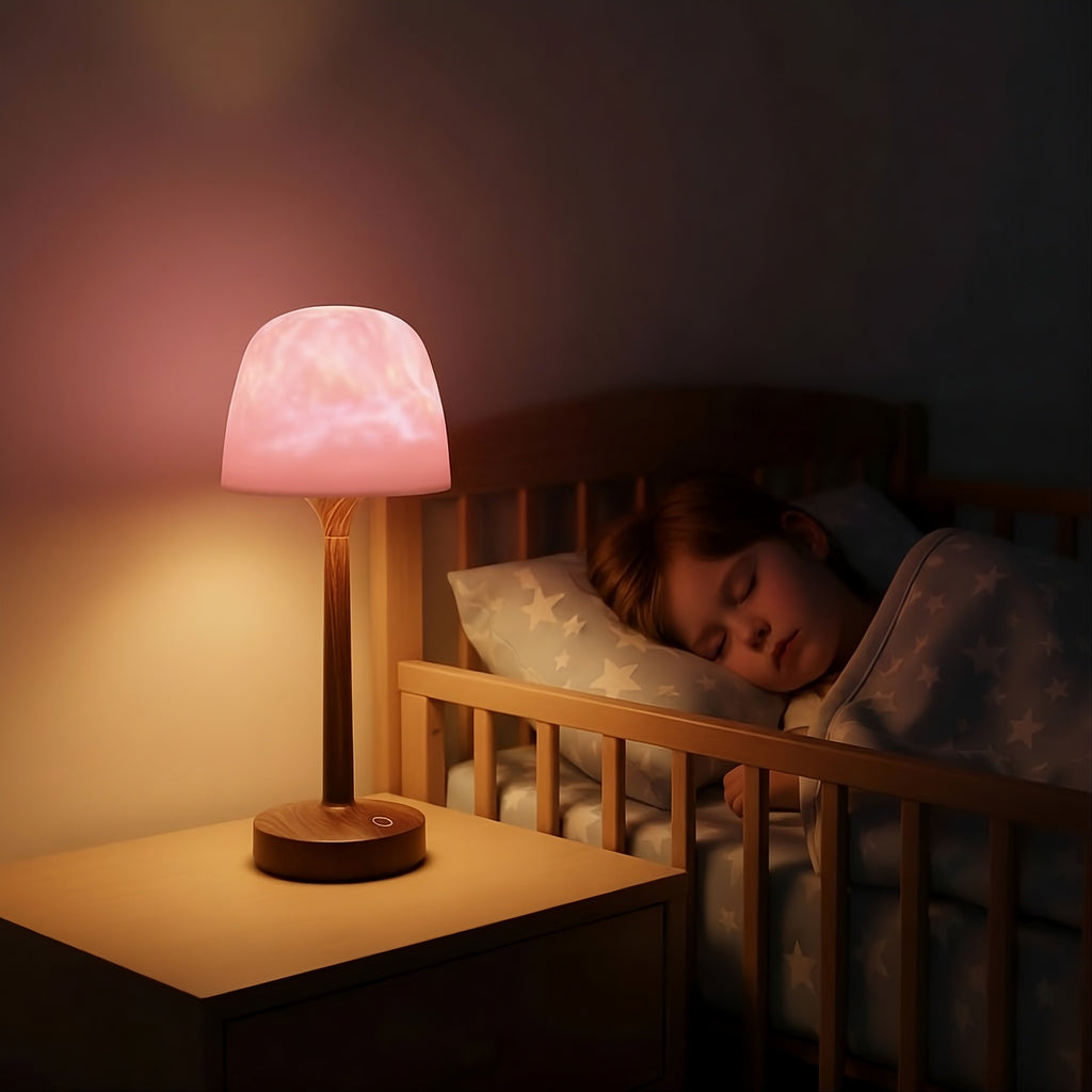 Soft glowing shower lamp on bedside table, child sleeping in crib at night